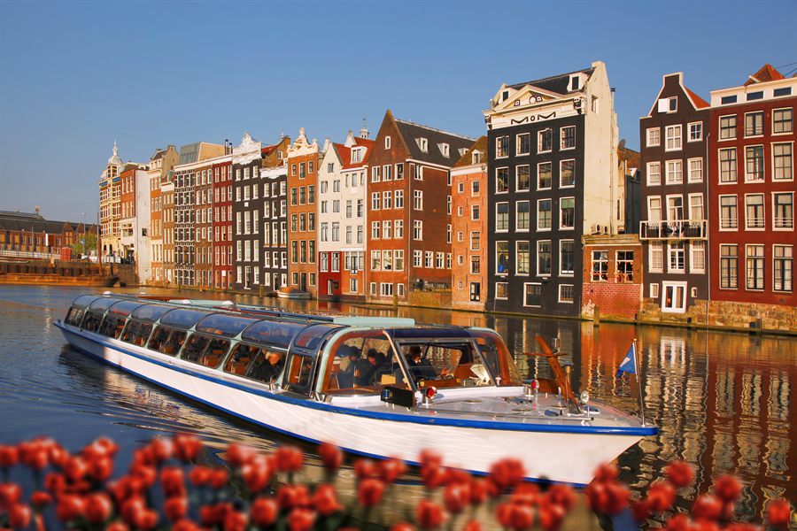 Canal boat in Amsterdam with tulips